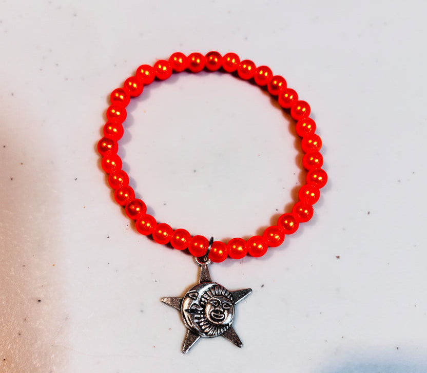 Bracelet - Stretch - Smooth Orange Pearl Like Beads with Silver Tone Star, Moon, Sun Charm