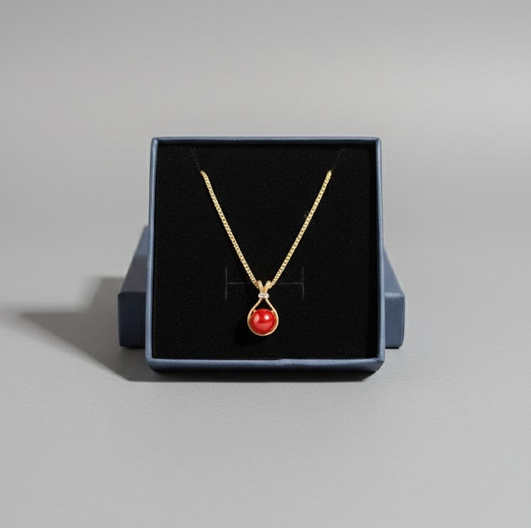 Gold Tone Necklace with Red Gem in a Teardrop Shaped Pendant