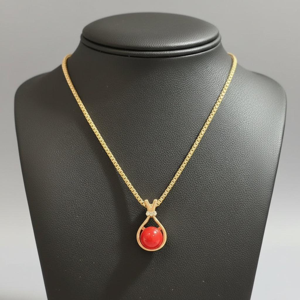 Gold Tone Necklace with Red Gem in a Teardrop Shaped Pendant